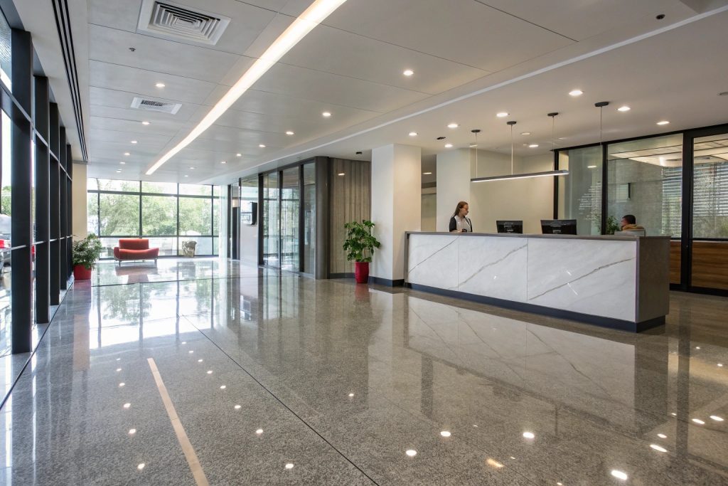 Modern office building lobby with grey epoxy flooring in Brisbane corporate space